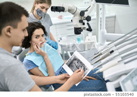 Pretty woman's teeth treatment in dental clinic 55103540