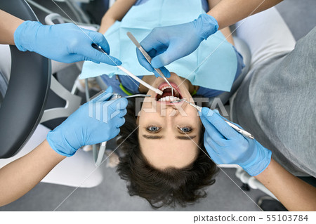 Pretty woman's teeth treatment in dental clinic 55103784