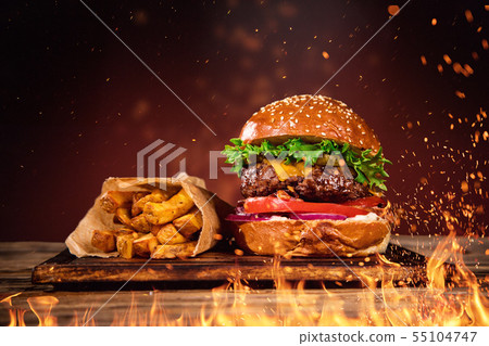 Tasty burger with french fries and fire. 55104747