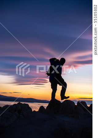 Happy man standing on cliff Happy man standing on cliff 55105802