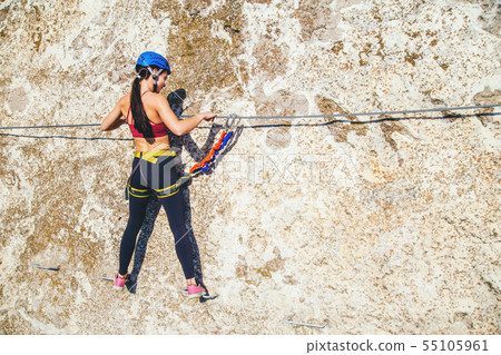 Woman climbing mountain.  55105961