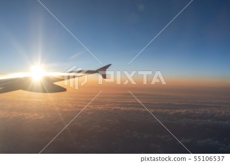 view of aircraft wing silhouette and dark blue sky 55106537