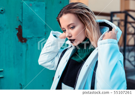 Blonde model with dark lipstick posing in winter jacket Blonde model with dark lipstick posing in winter jacket 55107261