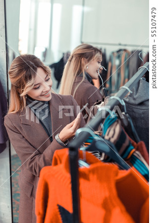 Appealing woman smiling after finding amazing dress 55107479