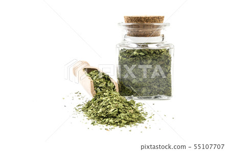 coriander leaves in wooden scoop and jar on coriander leaves in wooden scoop and jar on 55107707