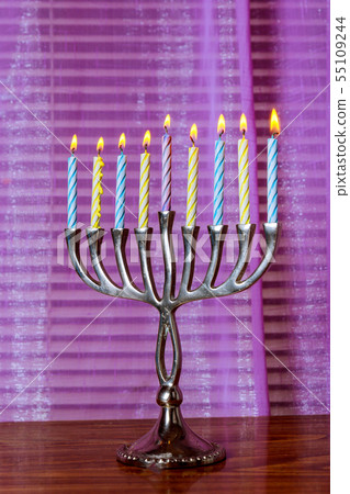 Brightly glowing Hanukkah menorah candles Brightly glowing Hanukkah menorah candles 55109244