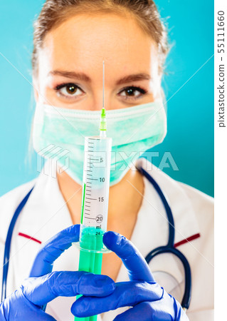 doctor in mask holding syringe with injection doctor in mask holding syringe with injection 55111660