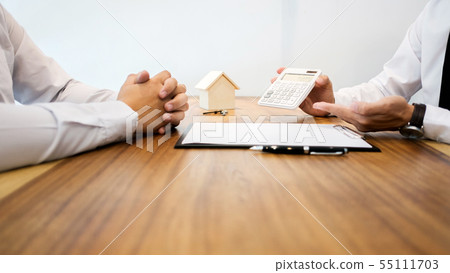 Real Estate agent showing a contract signature Real Estate agent showing a contract signature 55111703