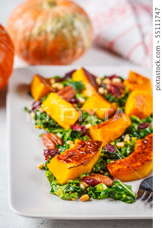 Pumpkin salad with nuts, cranberries and kale Pumpkin salad with nuts, cranberries and kale 55111747