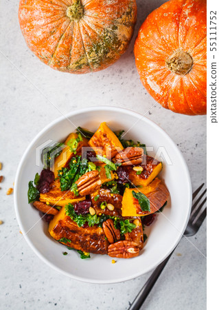 Pumpkin salad with nuts, cranberries and kale 55111752