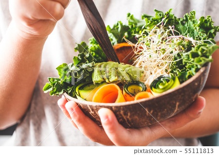 Healthy vegan lunch in a coconut bowl. Healthy vegan lunch in a coconut bowl. 55111813