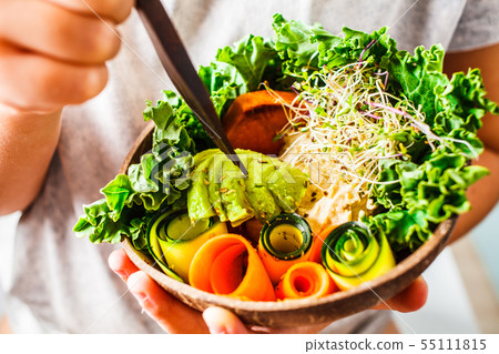 Healthy vegan lunch in a coconut bowl. Healthy vegan lunch in a coconut bowl. 55111815