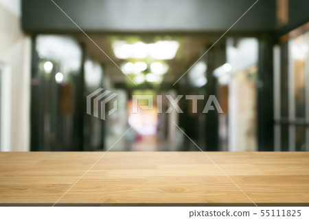 empty wooden desk over blurred coffee shop empty wooden desk over blurred coffee shop 55111825