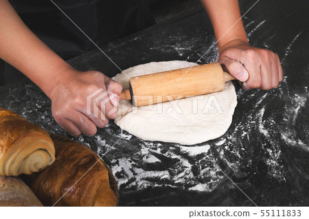 close up of man chef cooking processing dough close up of man chef cooking processing dough 55111833
