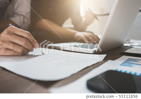 Business executives analyzing on valuation data Business executives analyzing on valuation data 55111856