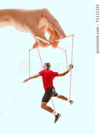 Man like a puppet in somebodies hands. Concept of manipulation Man like a puppet in somebodies hands. Concept of manipulation 55112183