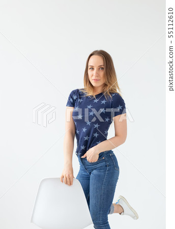 Portrait of a beautiful caucasian young woman posing against white wall background. The concept of a 55112610