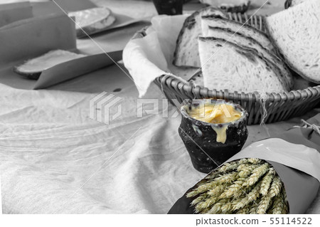 ceramic pot of melted butter brightly on a tinted 55114522