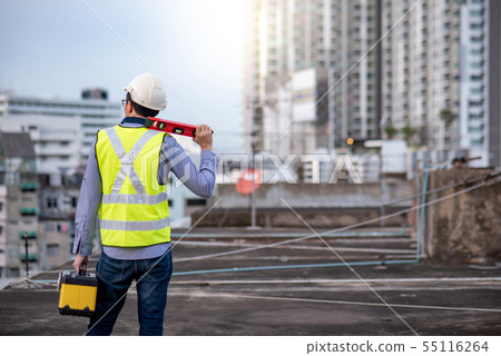 Worker man holding spirit level tool and box 55116264
