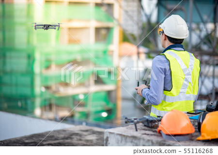 Asian engineer flying drone over construction site Asian engineer flying drone over construction site 55116268