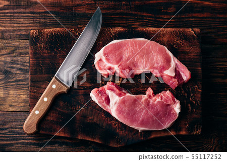 Two pork loin steaks with knife Two pork loin steaks with knife 55117252
