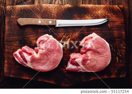 Two pork loin steaks with knife 55117254