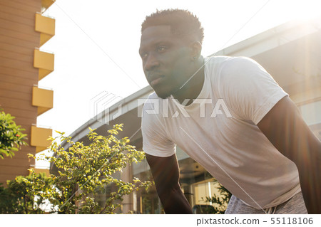 Portrait of African American man taking a rest during jogging Portrait of African American man taking a rest during jogging 55118106