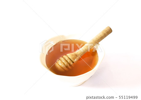 honey and wooden scoop in cup on white background honey and wooden scoop in cup on white background 55119499
