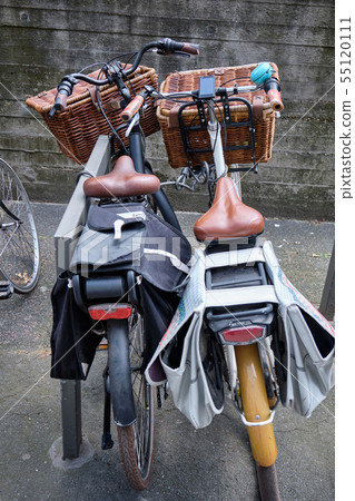 Two bicycles parked near each other 55120111
