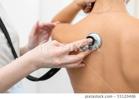 Woman doctor therapist listening with a Woman doctor therapist listening with a 55120486