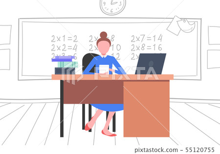 Female Teacher Sitting At Desk In Front Of Stock Illustration