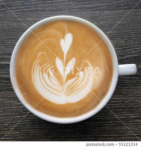 Top view of a mug of latte art coffee . Top view of a mug of latte art coffee . 55121314