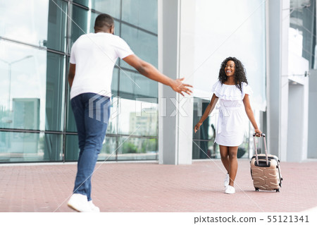 African guy picking up his girlfriend at airport 55121341
