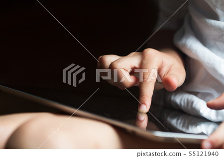 child hand touching the screen of a tablet child hand touching the screen of a tablet 55121940