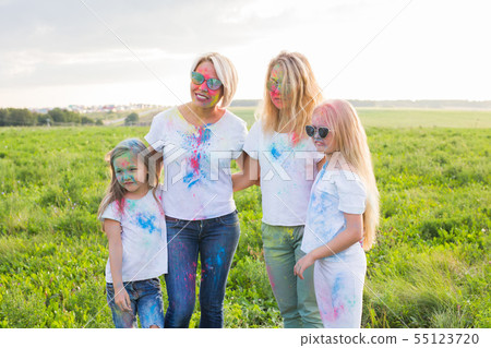 Holiday, summer and fun concept - Group of people dancing in field at holi festival Holiday, summer and fun concept - Group of people dancing in field at holi festival 55123720