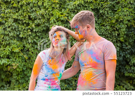 Friendship, festival of holi, people concept - young couple playing with colors at the festival of Friendship, festival of holi, people concept - young couple playing with colors at the festival of 55123723