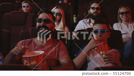 Father and son watching comedy in cinema 55124700