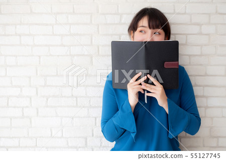 beautiful young asian woman happy hiding book beautiful young asian woman happy hiding book 55127745