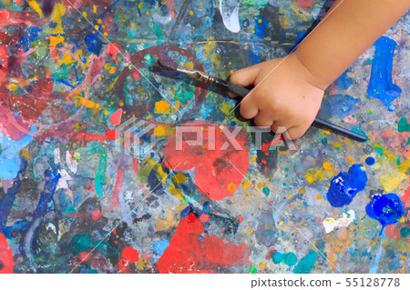 Hand baby holding brush paint color. 55128778