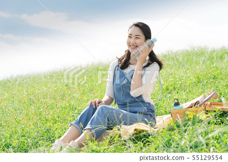 A woman with a plastic bottle A woman with a plastic bottle 55129554