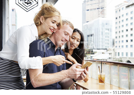 Friends reading text message Friends reading text message 55129808