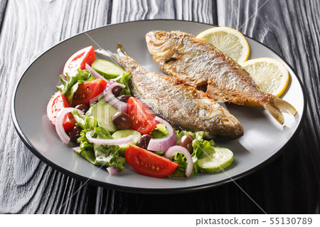 Portion of fried Salema porgy fish with lemon and Portion of fried Salema porgy fish with lemon and 55130789