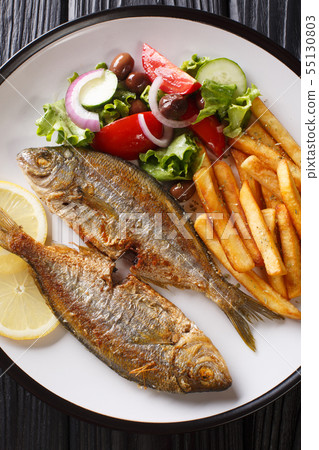 Fried Salema porgy fish with a side dish of fresh Fried Salema porgy fish with a side dish of fresh 55130803