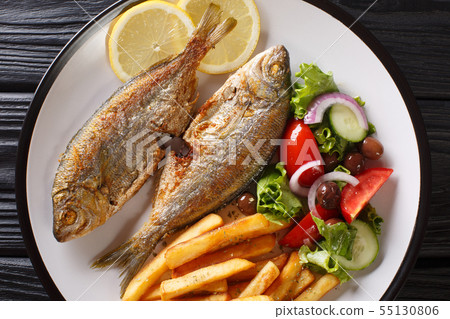 Fried Salema porgy fish with a side dish of fresh Fried Salema porgy fish with a side dish of fresh 55130806