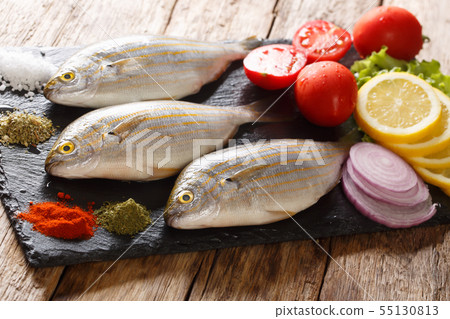 Freshly caught Sarpa salpa with raw vegetables and Freshly caught Sarpa salpa with raw vegetables and 55130813