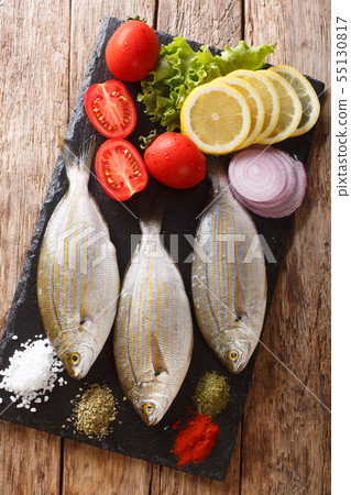 Raw Sarpa salpa with ingredients close-up on a Raw Sarpa salpa with ingredients close-up on a 55130817