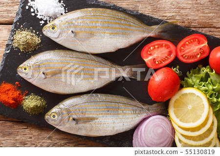 Freshly caught Sarpa salpa with raw vegetables and Freshly caught Sarpa salpa with raw vegetables and 55130819