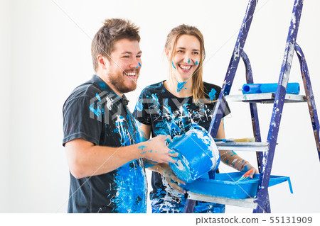Repair, renovation and people concept - Close up portrait of couple pour paint 55131909