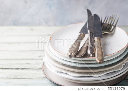 Stack of plates with cutlery 55135079
