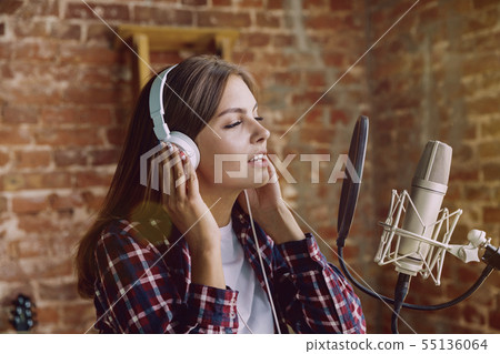 Woman recording music, broadcasting and singing at home 55136064